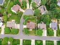Aerial view of a home nestled in a neighborhood featuring mature trees and well-maintained yards at 135 Coronilla Rd, Mooresville, NC 28117