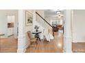 Inviting foyer with hardwood floors, staircase, and decorative accents that adds charm and character to the home at 135 Coronilla Rd, Mooresville, NC 28117