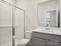 Bathroom featuring a shower, white toilet and a gray vanity with a white countertop at 140 Shepherds Landing Dr, Mooresville, NC 28115