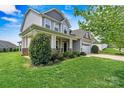 Side view of home with stone veneer accents, landscaped yard, and an attached two-car garage at 1617 Post Ct, Gastonia, NC 28054