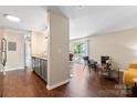 Open-concept living room with hardwood floors, flowing into kitchen at 1620#F Arlyn Cir, Charlotte, NC 28213