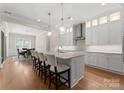 Modern kitchen with stainless steel appliances, granite countertops, and a view of the dining room at 17728 Jetton Green Loop, Cornelius, NC 28031