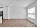 Spacious living room offering hardwood floors and abundant natural light from large windows at 1834 Teachers House Nw Rd, Concord, NC 28027