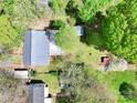 An aerial view showcasing the home's roof, surrounding trees, outbuildings, and yard offering a sense of the property's layout at 2106 4Th Ne St, Hickory, NC 28601