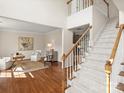 Open living space with hardwood floors, a staircase, and stylish seating creates a welcoming atmosphere at 213 Walnut Point Dr, Matthews, NC 28105