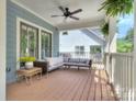 Relaxing outdoor porch with comfortable wicker seating, ceiling fan, and stylish decor for tranquil enjoyment at 2729 Clemson Ave, Charlotte, NC 28205