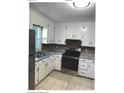Traditional kitchen with white cabinets, stainless steel appliances, and stone countertops at 2831 Denview Ln, Charlotte, NC 28208