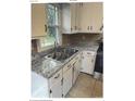 Bright kitchen with updated countertops, a stainless steel sink, and white cabinetry at 2831 Denview Ln, Charlotte, NC 28208