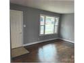 Bright living room with hardwood floors, large window, and fresh paint at 2831 Denview Ln, Charlotte, NC 28208