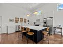 Modern kitchen with large island, stainless steel appliances, and sleek white cabinetry at 3036 Palm Ave, Charlotte, NC 28205