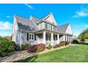 Beautifully landscaped home featuring a welcoming front porch and meticulously maintained lawn at 3068 Green Acres Ln, Claremont, NC 28610