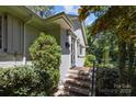 Inviting front entrance featuring brick steps, stylish lighting, and mature landscaping for added curb appeal at 311 Mcalway Rd, Charlotte, NC 28211