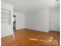 A spacious living room shows off hardwood floors and a built-in bookshelf in this home's living space at 343 Wakefield Dr # C, Charlotte, NC 28209