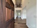 Grand foyer with hardwood floors, an open staircase and a view into the spacious open-concept living area at 4038 Gardenia Dr # 0114, Harrisburg, NC 28075