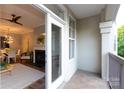 Inviting balcony view into a living room with a fireplace and dining area, creating a cozy transition at 405 W 7Th St # 408, Charlotte, NC 28202