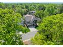 An aerial view of a luxurious home surrounded by lush greenery and mature trees in a serene neighborhood at 410 Mcalway Rd, Charlotte, NC 28211