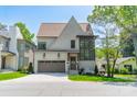 Beautiful two-story home boasts a brick exterior, a two-car garage, and professional landscaping at 410 Mcalway Rd, Charlotte, NC 28211