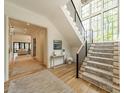 Inviting foyer with hardwood floors, staircase with large windows, and stylish decor at 410 Mcalway Rd, Charlotte, NC 28211