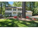 Inviting two-story home featuring a well-maintained exterior, classic shutters, and a professionally landscaped front lawn at 505 Southland Rd, Huntersville, NC 28078