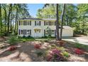 Beautiful two-story home boasting a bright facade, dark shutters, and lush landscaping, creating an inviting curb appeal at 505 Southland Rd, Huntersville, NC 28078
