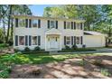 Classic two-story home featuring a well-maintained lawn, dark shutters and a covered front entry at 505 Southland Rd, Huntersville, NC 28078