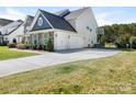 Spacious driveway leading to a three-car garage, plus a basketball hoop for outdoor fun at 5078 Hyannis Ct, Matthews, NC 28104