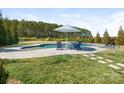 Relaxing backyard pool area with comfortable seating and a lush green lawn at 5078 Hyannis Ct, Matthews, NC 28104