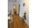 Bright hallway features hardwood floors leading to a bathroom, plus a charming wall decoration at 5228 Sunriver Rd, Gastonia, NC 28054