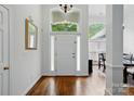 Bright entryway featuring hardwood floors, white trim, and elegant transom window above door at 530 Dovefield Dr, Indian Trail, NC 28079