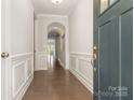 Elegant foyer with hardwood floors, arched entryway and neutral paint, creating a welcoming ambiance at 5684 Garrow Glen Rd # 96, Charlotte, NC 28278