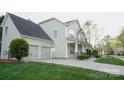 A charming home with a two-car garage and well-maintained landscaping at 5808 Mcdowell Run Dr, Huntersville, NC 28078