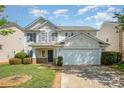 Charming two-story home with a well-manicured lawn and attached two-car garage with neutral siding at 6618 Latherton Ln, Charlotte, NC 28278