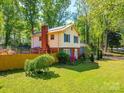Charming house surrounded by lush greenery, showcasing a serene and private outdoor space at 6820 Elm Forest Dr, Charlotte, NC 28212