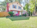 Attractive home with a well-maintained lawn, inviting entrance, and vibrant landscaping at 6820 Elm Forest Dr, Charlotte, NC 28212