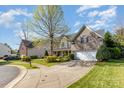 Lovely home showcasing a wide driveway and a meticulously landscaped front yard on a sunny day at 6941 Augustine Way, Charlotte, NC 28270