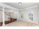 Bright living room with large windows, carpeted floors, and elegant architectural columns at 6941 Augustine Way, Charlotte, NC 28270
