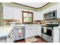 Bright kitchen with white cabinets, stainless steel appliances, and a window over the sink at 7020 Leesburg Rd, Charlotte, NC 28215