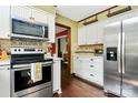 Updated kitchen featuring stainless steel appliances, white cabinets, and hardwood floors at 7020 Leesburg Rd, Charlotte, NC 28215