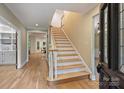 Bright foyer with hardwood floors and staircase leading to the second floor at 7067 Rocky Falls Rd, Charlotte, NC 28211