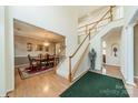 Grand foyer featuring a staircase with wooden handrails and a view into the dining room at 709 Circle Trace Rd, Monroe, NC 28110