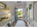 Charming foyer featuring hardwood floors, decorative accents, a statement mirror and French doors at 7693 Lazy Hollow Ln, Denver, NC 28037