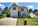 Charming two-story home with attached garage, landscaped front yard and front porch at 773 Sir Raleigh Dr, Concord, NC 28025