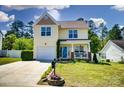 Well-maintained two-story home with garage, landscaping and front porch seating area at 773 Sir Raleigh Dr, Concord, NC 28025