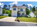 Lovely two-story home with garage, landscaping and cozy front porch seating area at 773 Sir Raleigh Dr, Concord, NC 28025