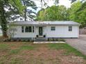 Charming single-story home featuring a metal roof, white siding, and well-manicured front lawn at 8475 Nc 49 N Hwy, Mount Pleasant, NC 28124