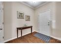 Elegant entryway with hardwood floors, console table, and decorative artwork at 985 Angelica Ln, Tega Cay, SC 29708