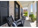 Charming front porch with comfortable rocking chairs and a well-decorated entrance at 1052 Harlow'S Crossing Dr, Weddington, NC 28104