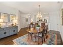 Well-lit dining space connecting to an open floor plan that shows the kitchen and living area at 1123 Park West Dr, Charlotte, NC 28209