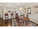 Inviting dining area with a wooden table, chandelier, and seamlessly connects to the kitchen at 1123 Park West Dr, Charlotte, NC 28209