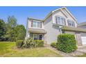 Inviting two-story townhouse with well-maintained lawn, brick accents, and an attached single car garage at 12027 Stratfield Place Cir, Pineville, NC 28134